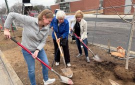 Mayor Annalee Sams (left) joins with the shoveling to plant a tree sapling at the John Davis Recreation Center on Wednesday duri