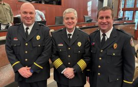 Captain Donnie Blankenship (left) and Captain Justin Rishel (right) pose with Chief Matt Daniel during Tuesday's meeting of the 