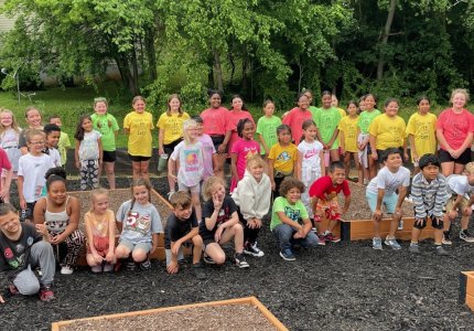 Westwood Elementary school students pose by their school's new garden beds at the Trammell Street garden