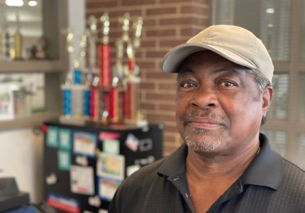 Tom Pinson poses in his office at the Mack Gaston Community Center