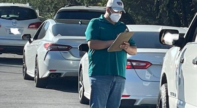 A volunteer checks in people for their appointments at a recent Regeneron clinic