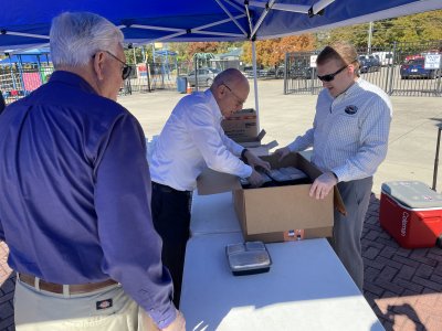 City Councilmember-Elect Steve Farrow helps City Administrator Andrew Parker unload more boxed lunches