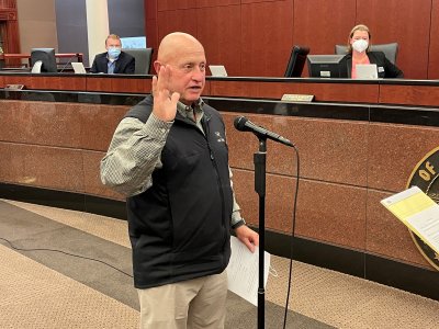 Dennis Mock takes the oath of office