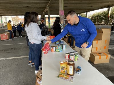 a volunteer organizes canned food donations