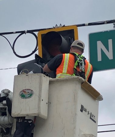 An employee of the Public Works Department's Traffic Division works to install a traffic light