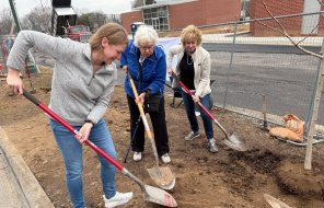 Mayor Annalee Sams (left) joins with the shoveling to plant a tree sapling at the John Davis Recreation Center on Wednesday duri
