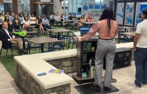 Chamber of Commerce board members Viviana and Carlos Ramirez speak to the Hispanic engagement meeting Friday at the JA Discovery