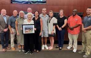 Members of the late Mayor Jim Middleton's family pose with the Mayor and Council 