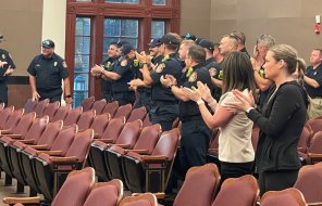 Retiring Engineer Anthony Johnston is applauded by his fellow firefighters Tuesday