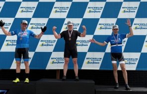 Dalton firefighter Douglas Kerns (left) stands on the awards podium after finishing second in the cyclinc competition at the Mic