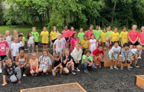 Westwood Elementary school students pose by their school's new garden beds at the Trammell Street garden