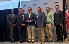 Dalton Public Works staff pose together on a stage after winning an award