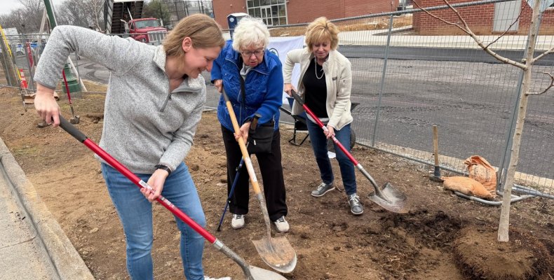 Mayor Annalee Sams (left) joins with the shoveling to plant a tree sapling at the John Davis Recreation Center on Wednesday duri