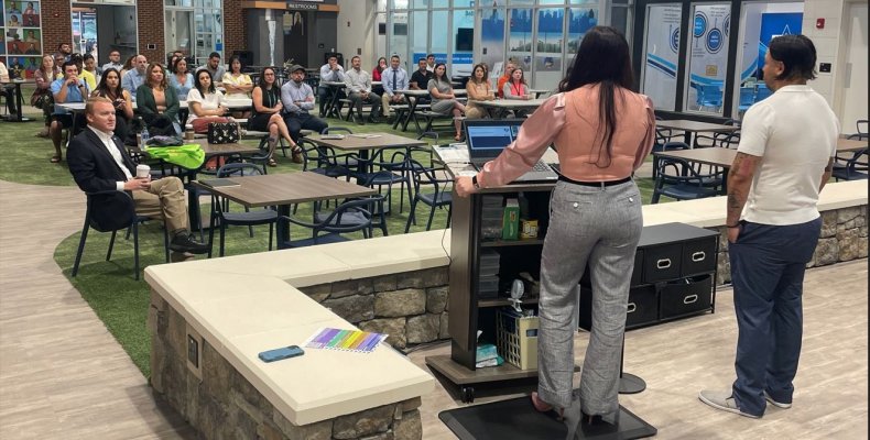 Chamber of Commerce board members Viviana and Carlos Ramirez speak to the Hispanic engagement meeting Friday at the JA Discovery