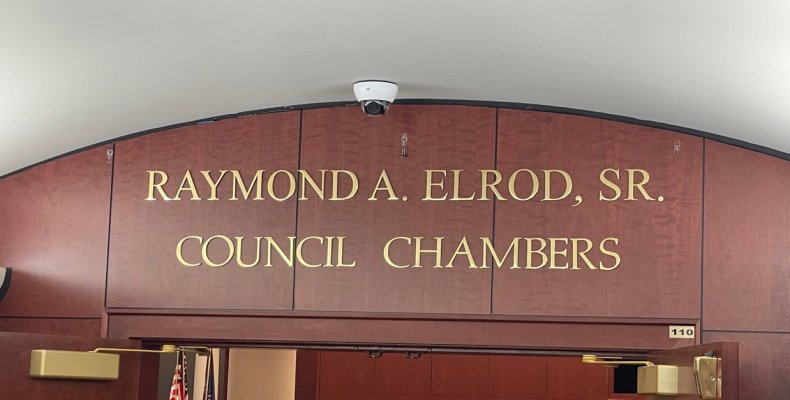 Newly unveiled signage designates the Raymond A. Elrod, Sr. Council Chambers 