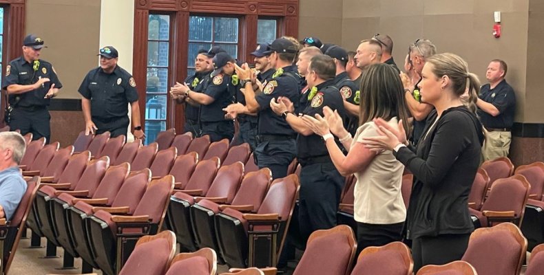 Retiring Engineer Anthony Johnston is applauded by his fellow firefighters Tuesday