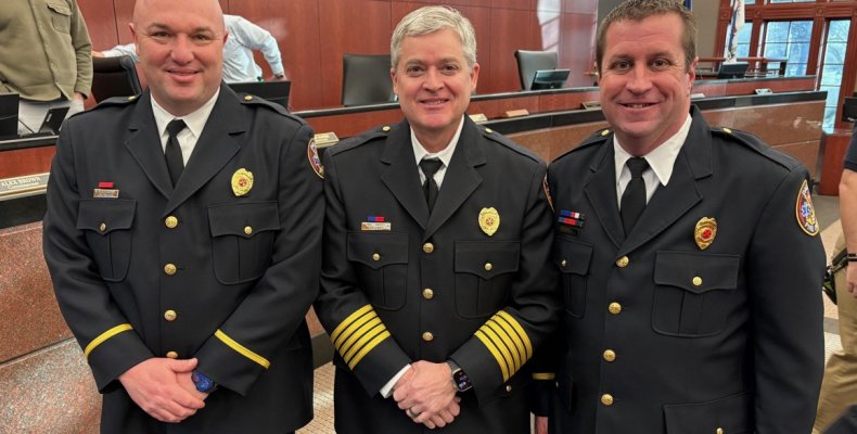 Captain Donnie Blankenship (left) and Captain Justin Rishel (right) pose with Chief Matt Daniel during Tuesday's meeting of the 