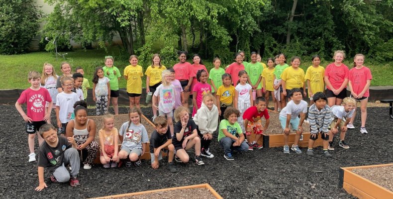 Westwood Elementary school students pose by their school's new garden beds at the Trammell Street garden