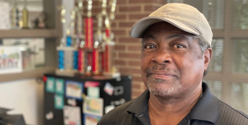 Tom Pinson poses in his office at the Mack Gaston Community Center
