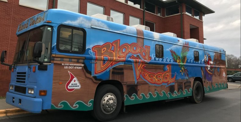 One of the mobile blood donation buses parked outside of the police department at a recent blood drive