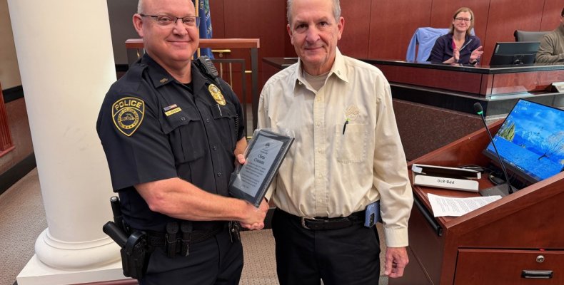 Assistant Police Chief Chris Crossen (left) shakes hands with Dalton Elks Lodge Trustee Vance Rhodes (right) after receiving a c