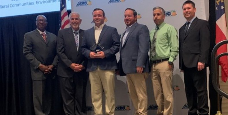 Dalton Public Works staff pose together on a stage after winning an award